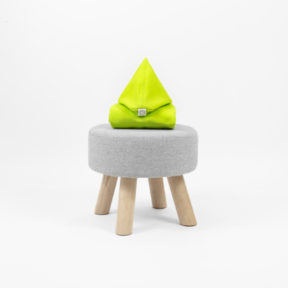 Citrus lime dog clothing with a pointy hood displayed on little chair.