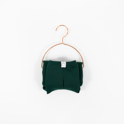 Cozy Waistcoat in color of Pine Green displayed on a hanger.