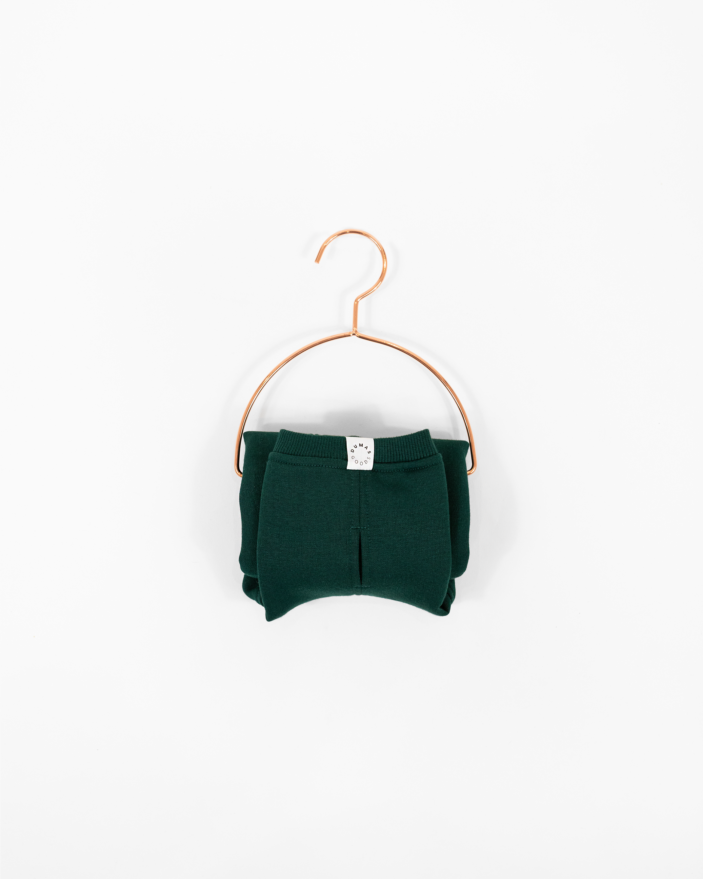 Cozy Waistcoat in color of Pine Green displayed on a hanger.