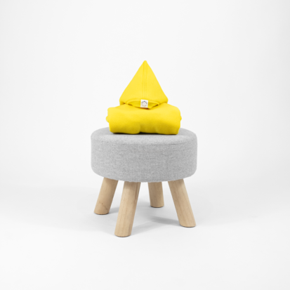 Yellow dog clothing with a pointy hood displayed on little chair.