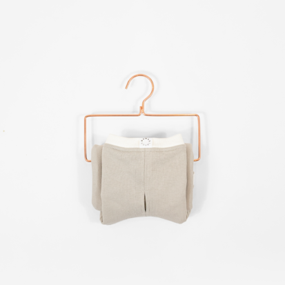Cozy Waistcoat in color of Sand Stone white displayed on a hanger.