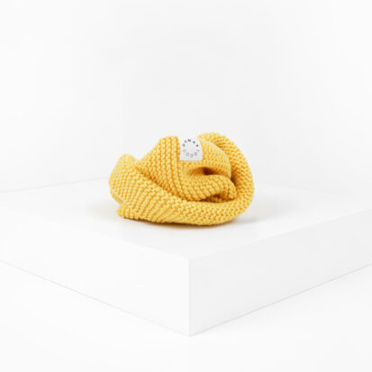 Banana Hand knitted snood for dogs depicted in white studio.