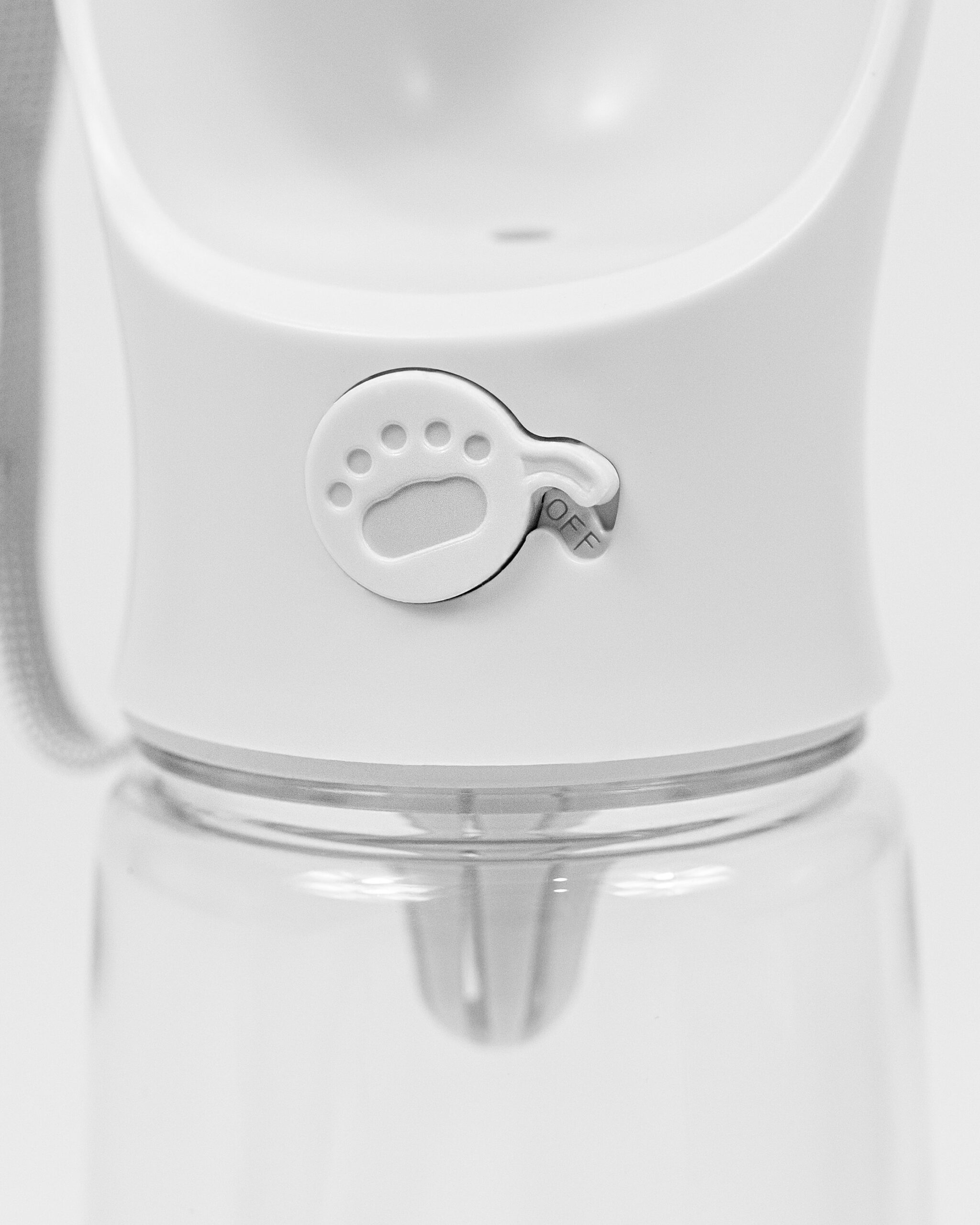DumasGoods-travel-cup-water-bottle-button The close up of the button that makes dog's water bottle release the water into the cup