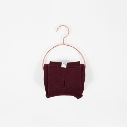 Cozy Waistcoat in color of Primitivo Red Wine displayed on a hanger.