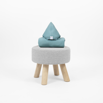Iceberg shark jumpsuit with a pointy hood displayed on a little chair.