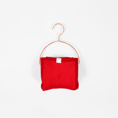 Cozy Waistcoat in red color displayed on a hanger.